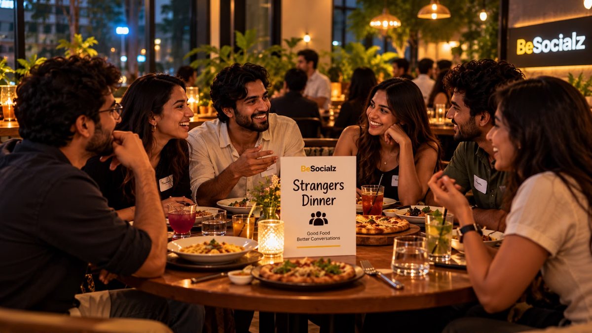 Six people laughing at a BeSocialz strangers dinner table at a restaurant