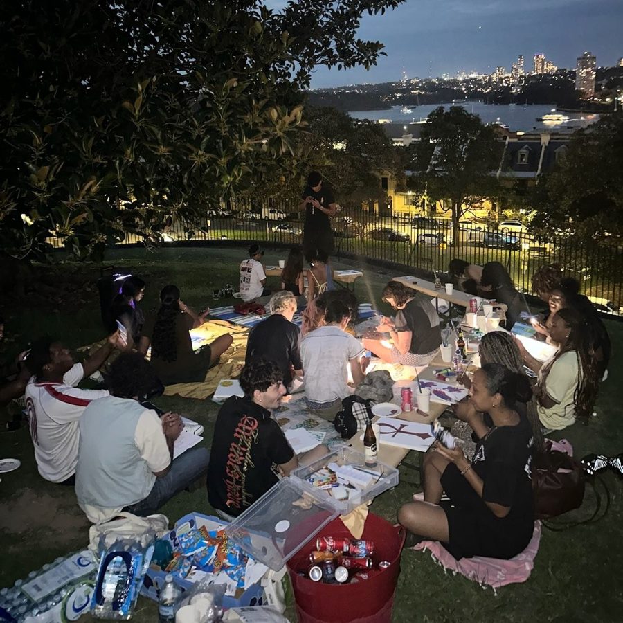 Friends painting together in a park at dusk